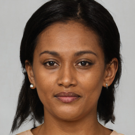 Joyful black young-adult female with medium  black hair and brown eyes