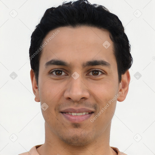 Joyful latino young-adult male with short  black hair and brown eyes