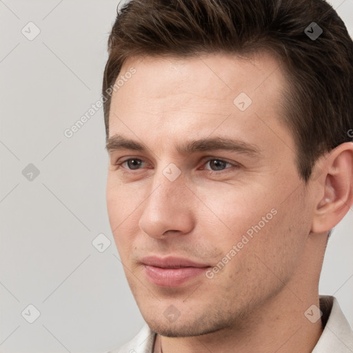 Joyful white young-adult male with short  brown hair and brown eyes