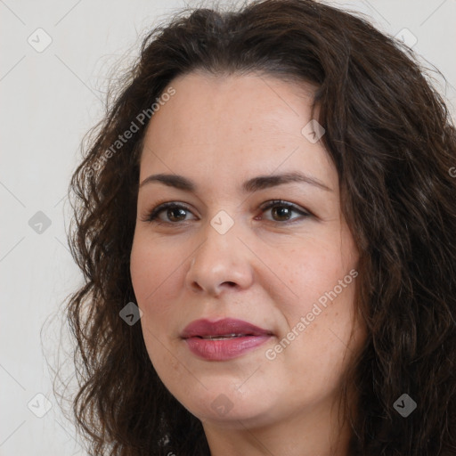 Joyful white adult female with long  brown hair and brown eyes