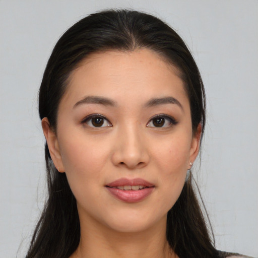 Joyful asian young-adult female with long  brown hair and brown eyes