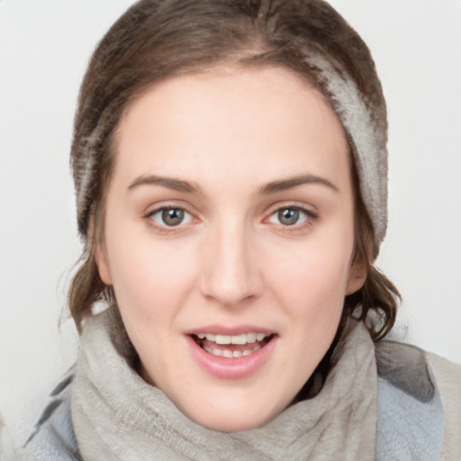 Joyful white young-adult female with medium  brown hair and blue eyes