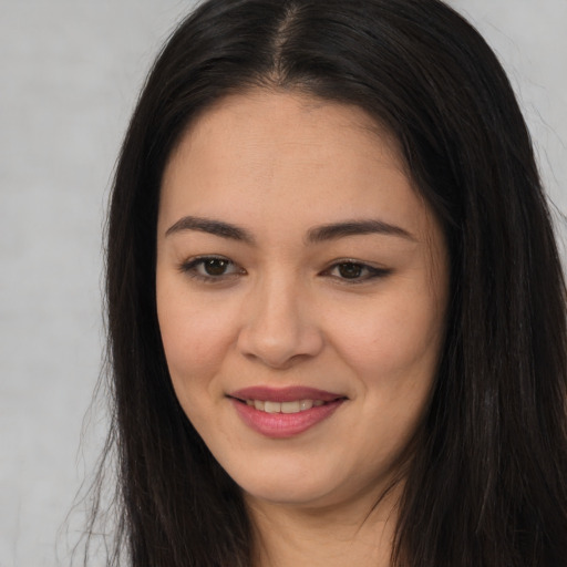 Joyful asian young-adult female with long  brown hair and brown eyes
