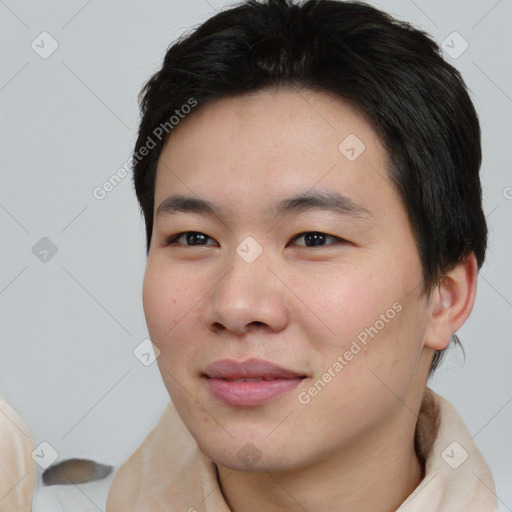 Joyful asian young-adult male with short  black hair and brown eyes