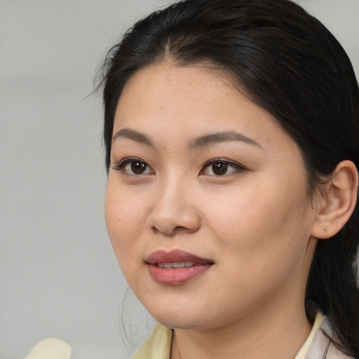 Joyful asian young-adult female with medium  brown hair and brown eyes