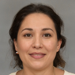 Joyful white adult female with medium  brown hair and brown eyes