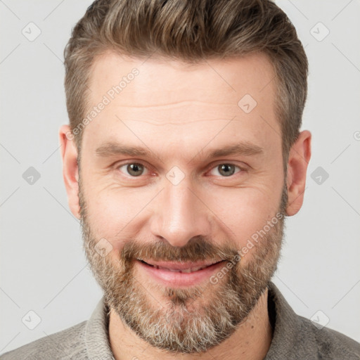 Joyful white adult male with short  brown hair and brown eyes