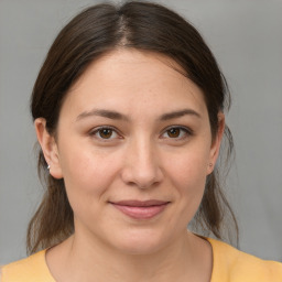 Joyful white young-adult female with medium  brown hair and brown eyes