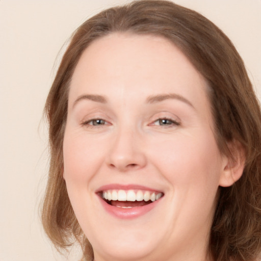 Joyful white young-adult female with long  brown hair and grey eyes