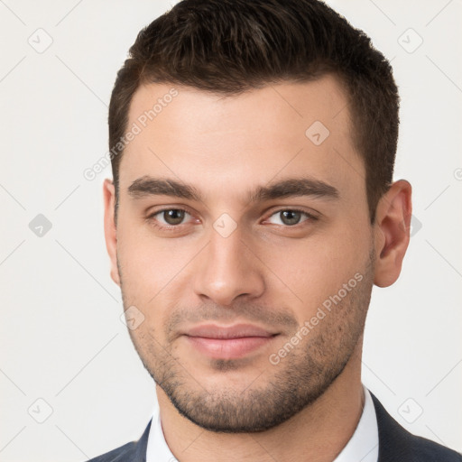 Joyful white young-adult male with short  brown hair and brown eyes