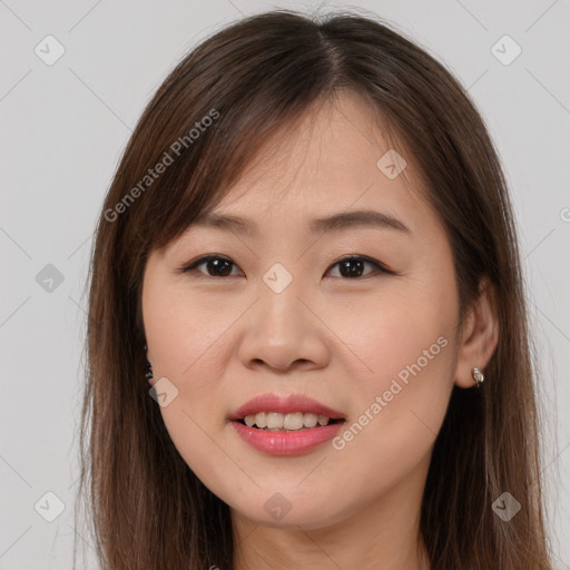 Joyful asian young-adult female with long  brown hair and brown eyes