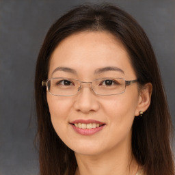 Joyful white adult female with long  brown hair and brown eyes