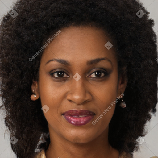 Joyful black young-adult female with long  brown hair and brown eyes