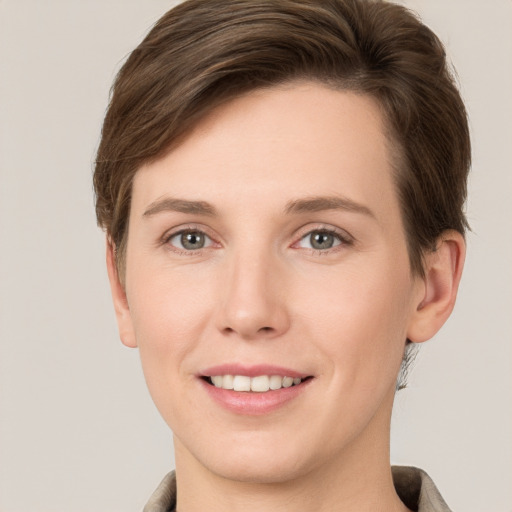 Joyful white young-adult female with short  brown hair and grey eyes