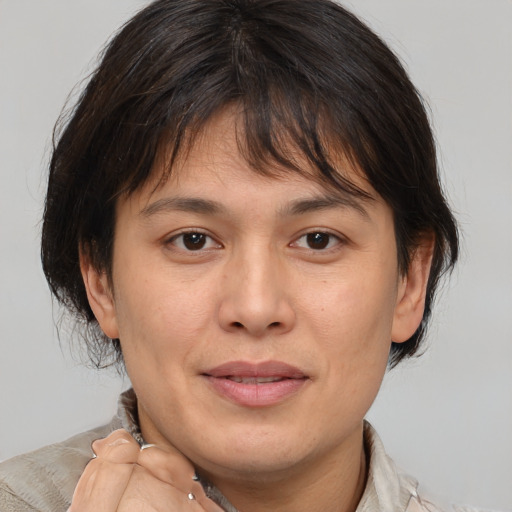 Joyful white adult female with medium  brown hair and brown eyes