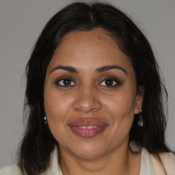 Joyful black adult female with medium  brown hair and brown eyes