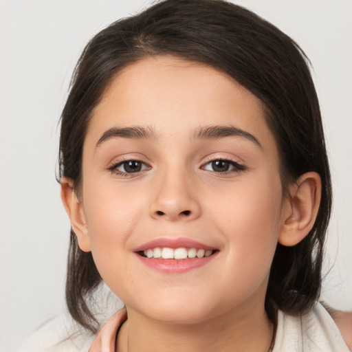 Joyful white child female with medium  brown hair and brown eyes