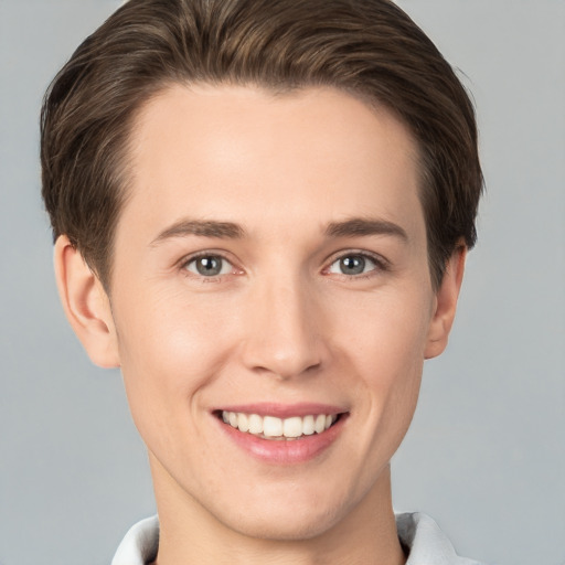 Joyful white young-adult female with short  brown hair and grey eyes