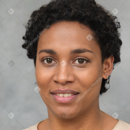 Joyful black young-adult female with short  brown hair and brown eyes