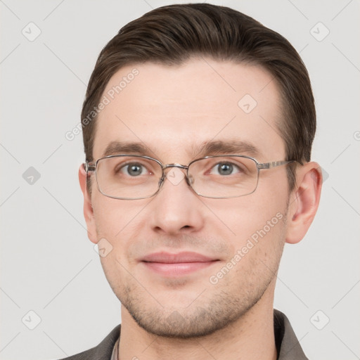 Joyful white young-adult male with short  brown hair and grey eyes