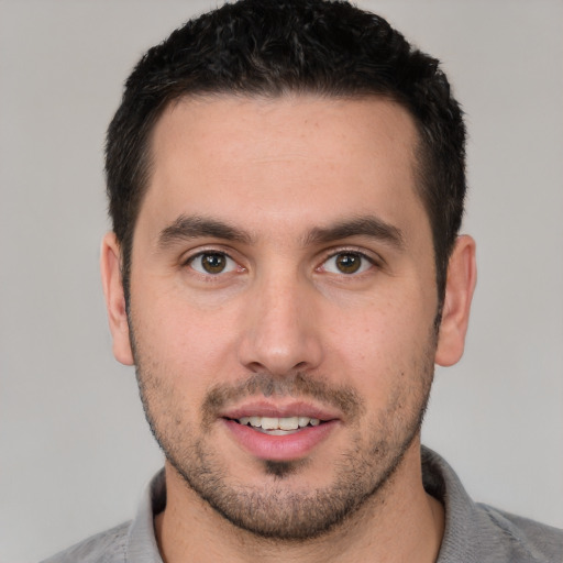 Joyful white young-adult male with short  brown hair and brown eyes