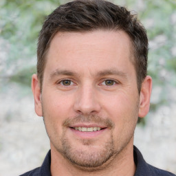 Joyful white adult male with short  brown hair and grey eyes