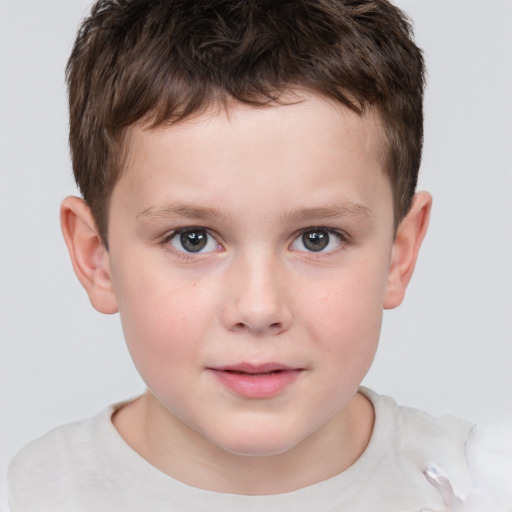 Joyful white child male with short  brown hair and grey eyes