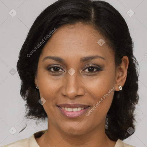 Joyful black adult female with medium  brown hair and brown eyes