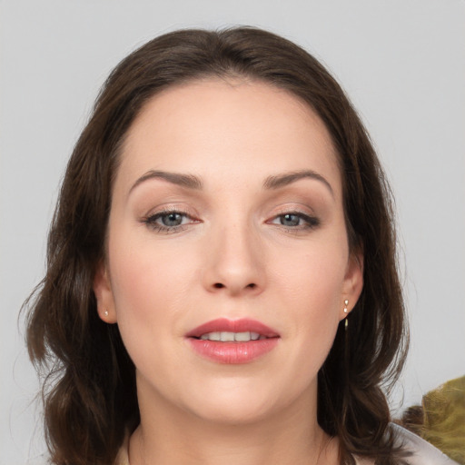 Joyful white young-adult female with medium  brown hair and grey eyes