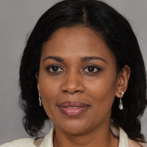 Joyful black young-adult female with medium  brown hair and brown eyes
