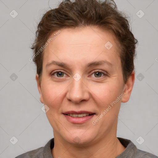 Joyful white adult female with short  brown hair and grey eyes