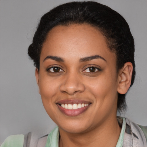 Joyful latino young-adult female with short  black hair and brown eyes