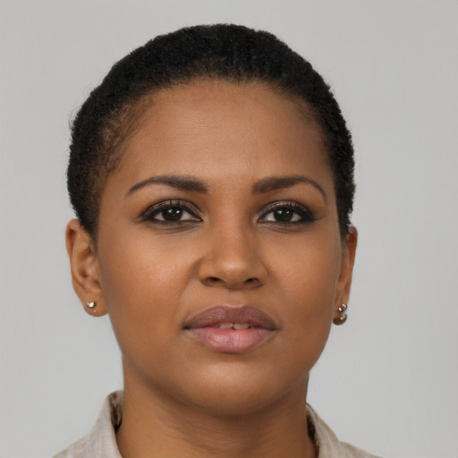 Joyful black young-adult female with short  brown hair and brown eyes