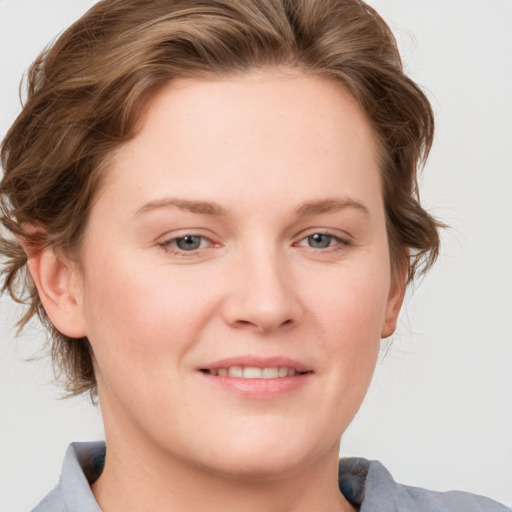 Joyful white young-adult female with medium  brown hair and blue eyes