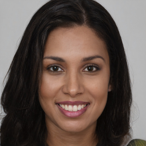 Joyful white young-adult female with long  brown hair and brown eyes