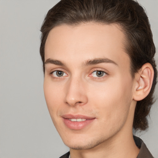 Joyful white young-adult male with medium  brown hair and brown eyes