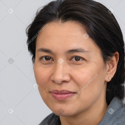 Joyful white adult female with medium  brown hair and brown eyes