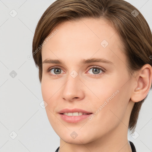 Joyful white young-adult female with short  brown hair and grey eyes