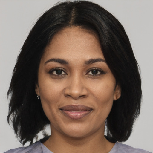 Joyful black young-adult female with medium  black hair and brown eyes