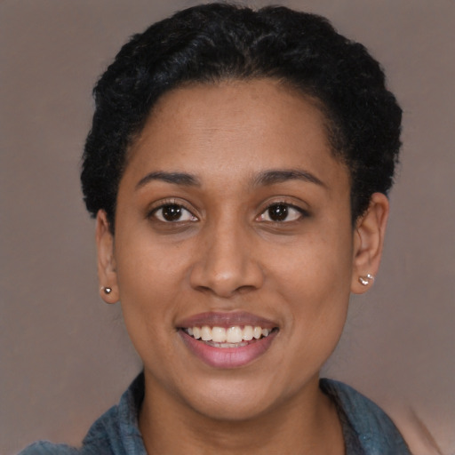 Joyful latino young-adult female with short  black hair and brown eyes