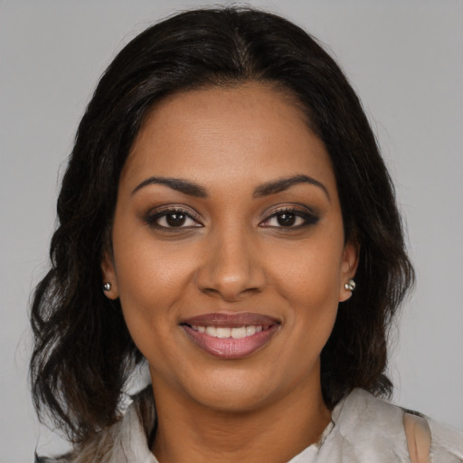 Joyful black young-adult female with medium  brown hair and brown eyes