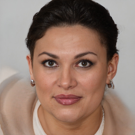 Joyful latino young-adult female with short  brown hair and brown eyes