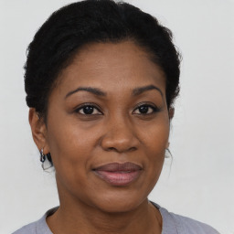 Joyful black adult female with short  black hair and brown eyes