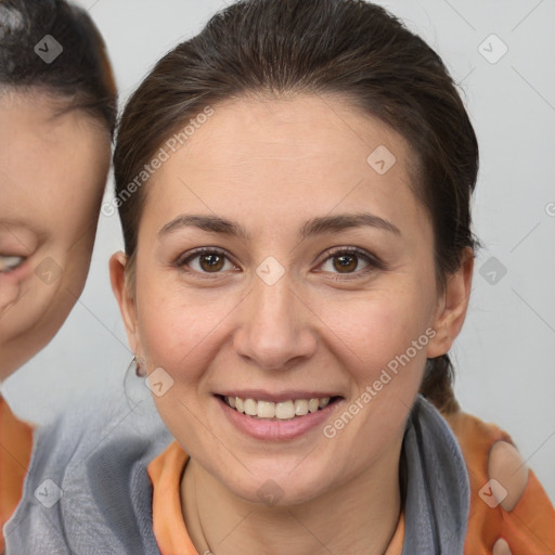 Joyful white adult female with medium  brown hair and brown eyes