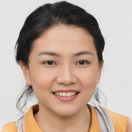 Joyful asian young-adult female with medium  brown hair and brown eyes