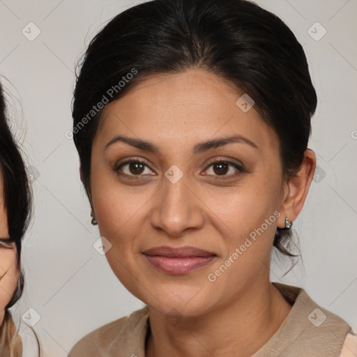 Joyful latino adult female with medium  brown hair and brown eyes