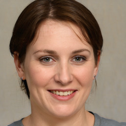 Joyful white adult female with medium  brown hair and grey eyes