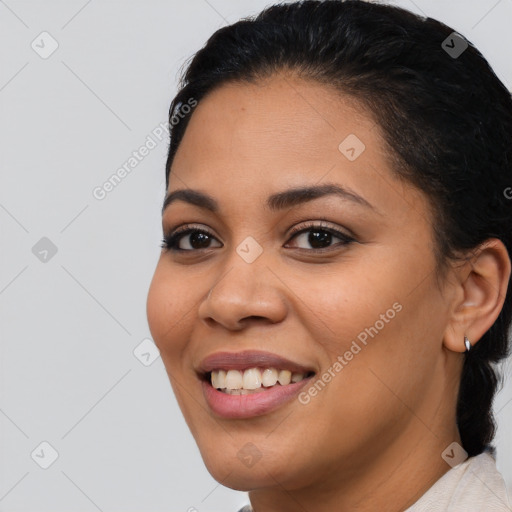 Joyful latino young-adult female with medium  brown hair and brown eyes