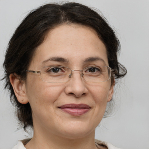 Joyful white adult female with medium  brown hair and brown eyes