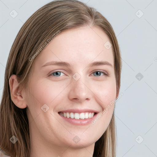 Joyful white young-adult female with long  brown hair and blue eyes